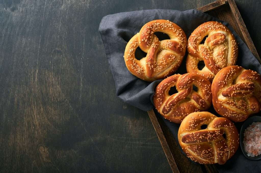 Bavarian pretzels and glass of lager beer. Oktoberfest food menu, traditional salted pretzels over o