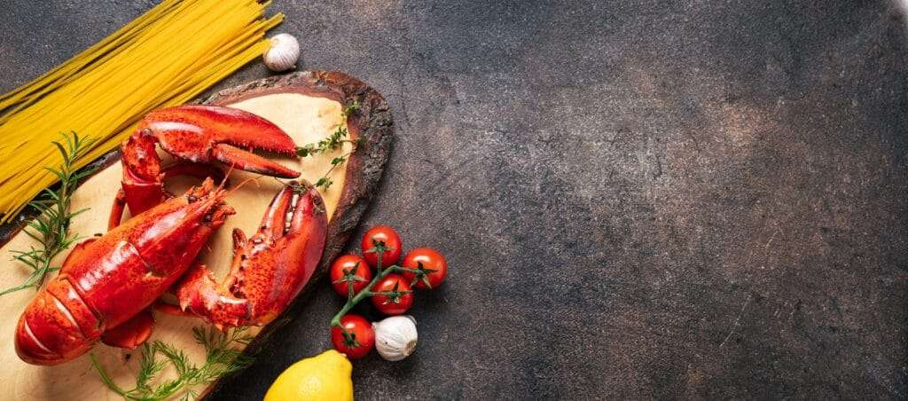 Food background with lobster and pasta