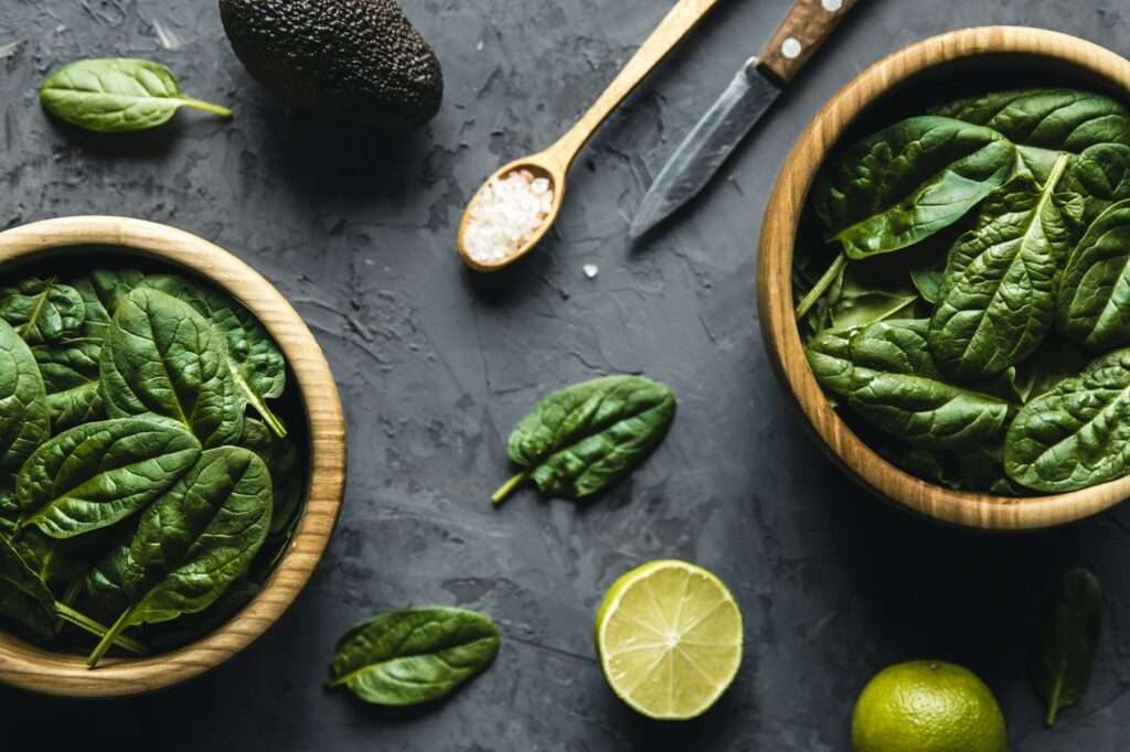 Green food background on stone table top view. Healthy food, vegan, eco products.