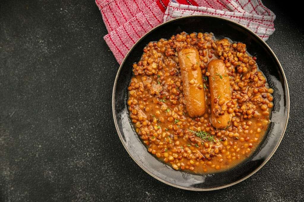 Lentil with sausage tasty food dish second course fresh gourmet food background on the table rustic