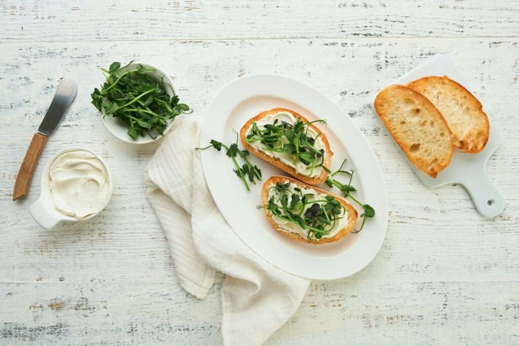 Toast or sandwich with cream cheese and micro greens peas and sunflower. Concept healthy food or sna